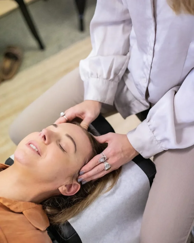 Dr Chelsea performing chiropractic adjustment to help a patient with their headaches