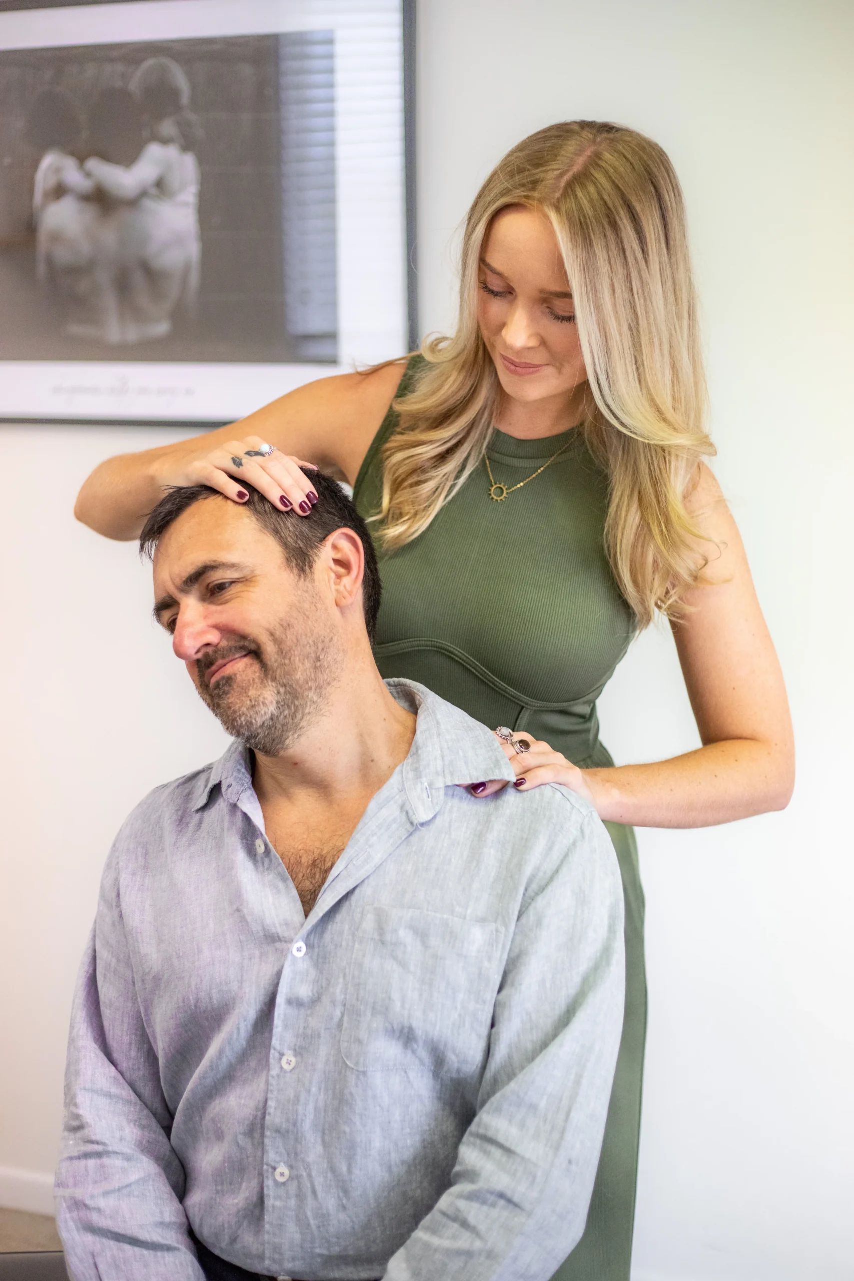 Dr Chelsea helping patient with neck pain stretch