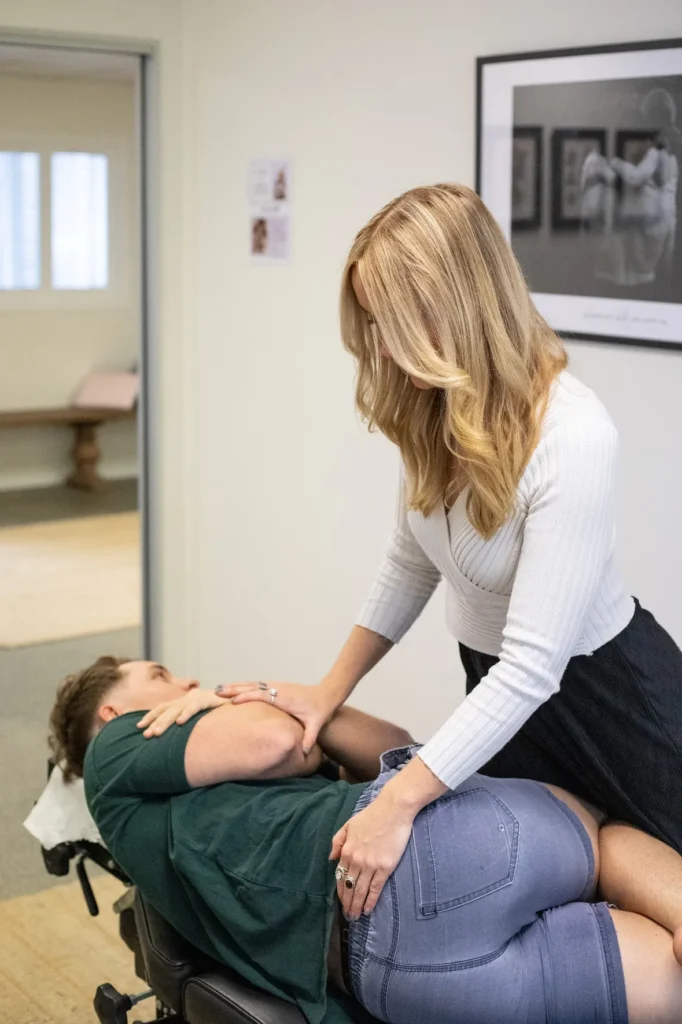 Dr Chelsea performing side posture chiropractic adjustment