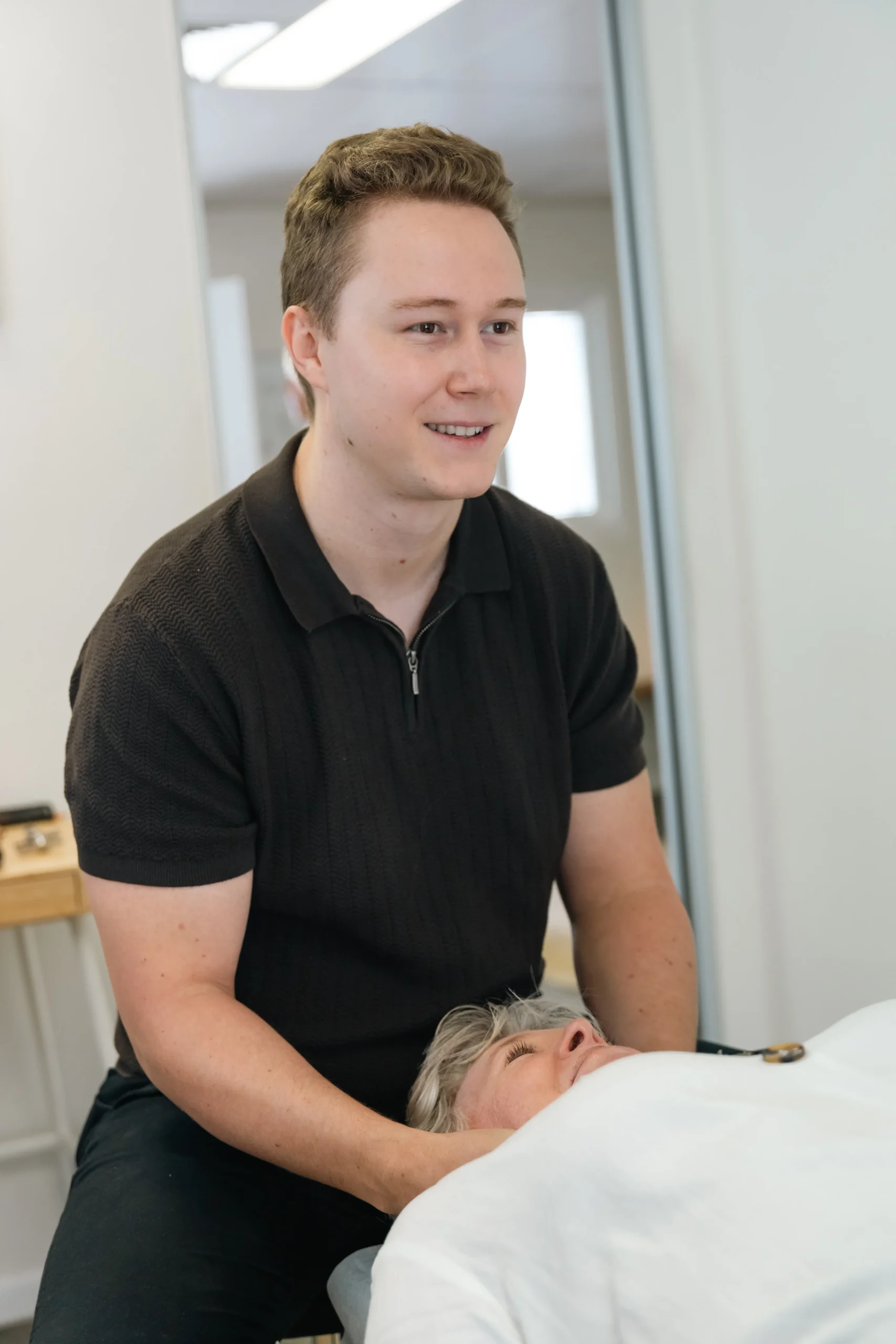 Dr Ben helping person neck pain