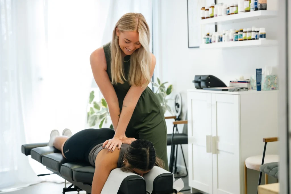 Chiropractic doctor helping patient